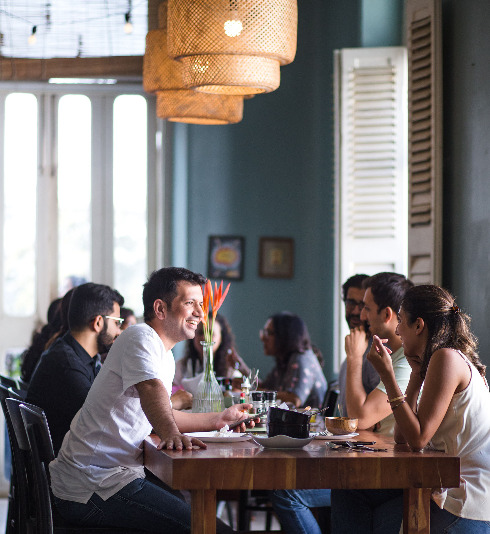 people sitting in a cafe and talking