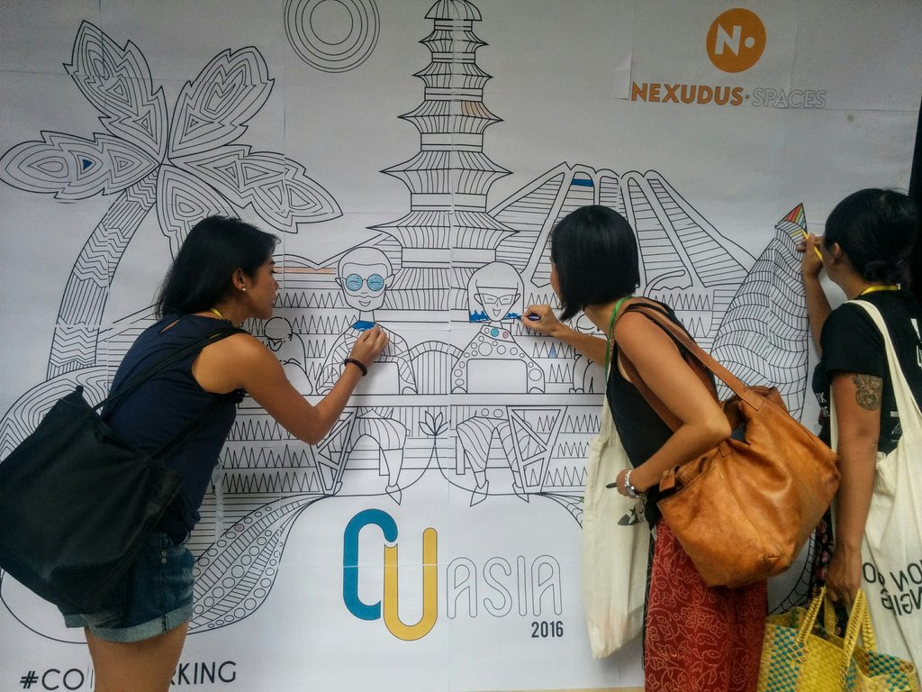 women coloring the cuasia 2016 event banner