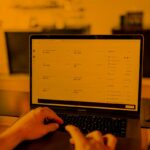 hands typing on laptop