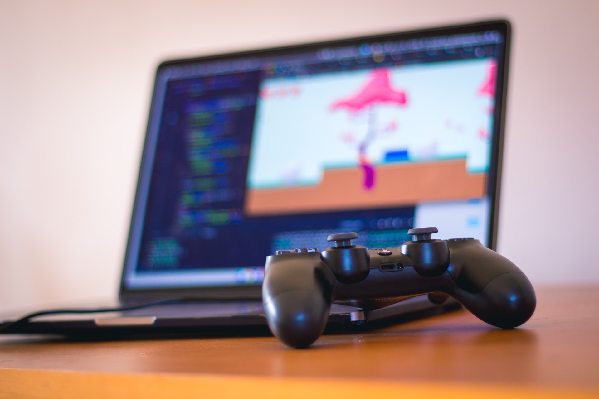 joystick on table, laptop in background