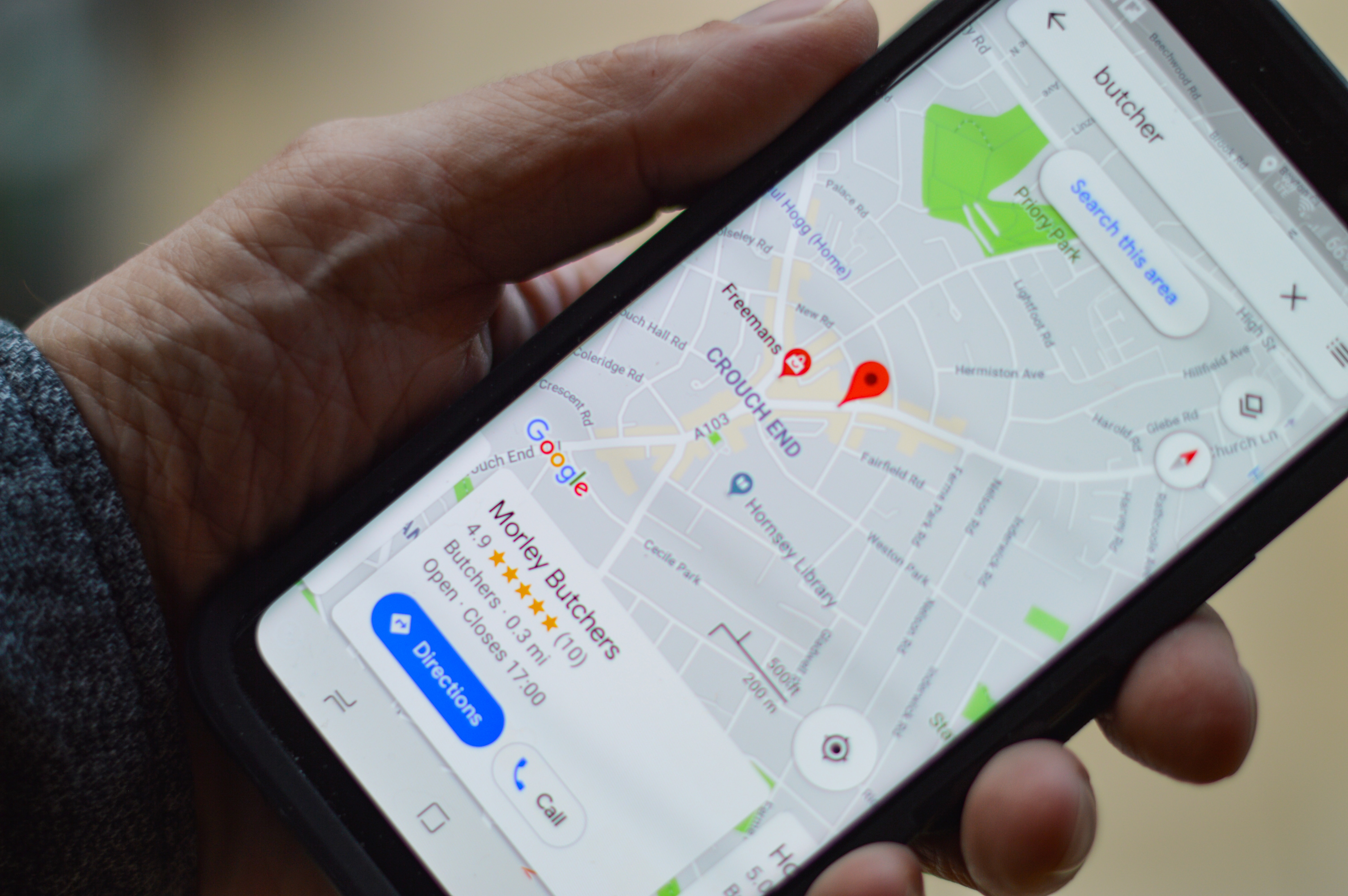 smartphone in hand. morley butchers google maps location on screen