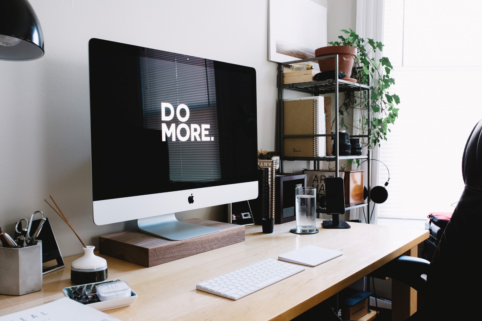 office desk, monitor with "do more."