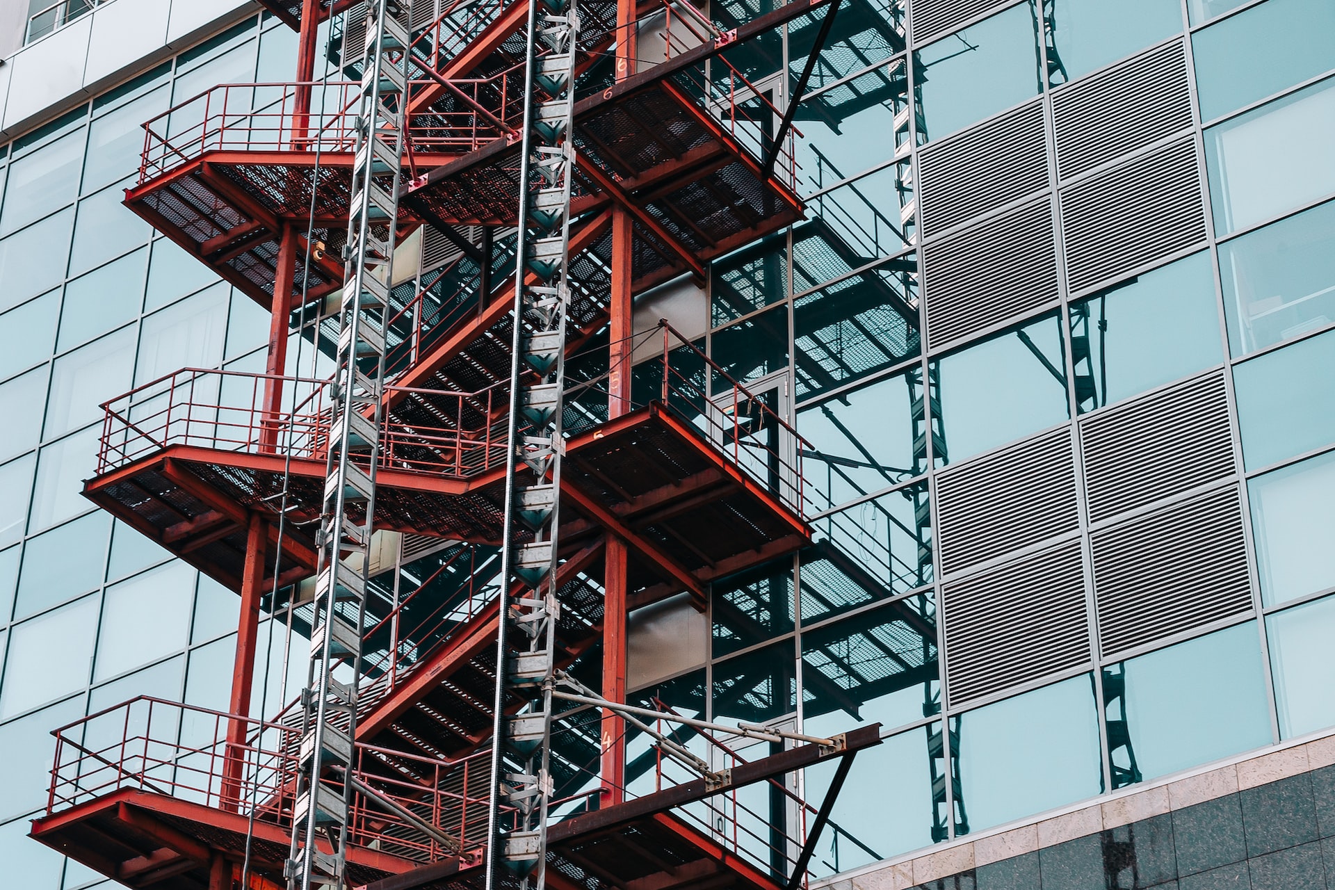 stairs on the outside of a glass building