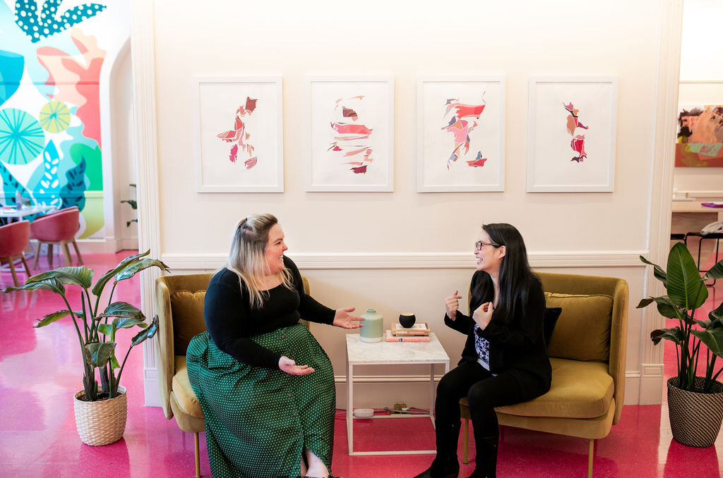 two women sitting and talking at the The Coven coworking spaces