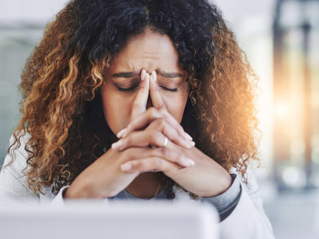Shot of a young businesswoman looking stressed out in an office