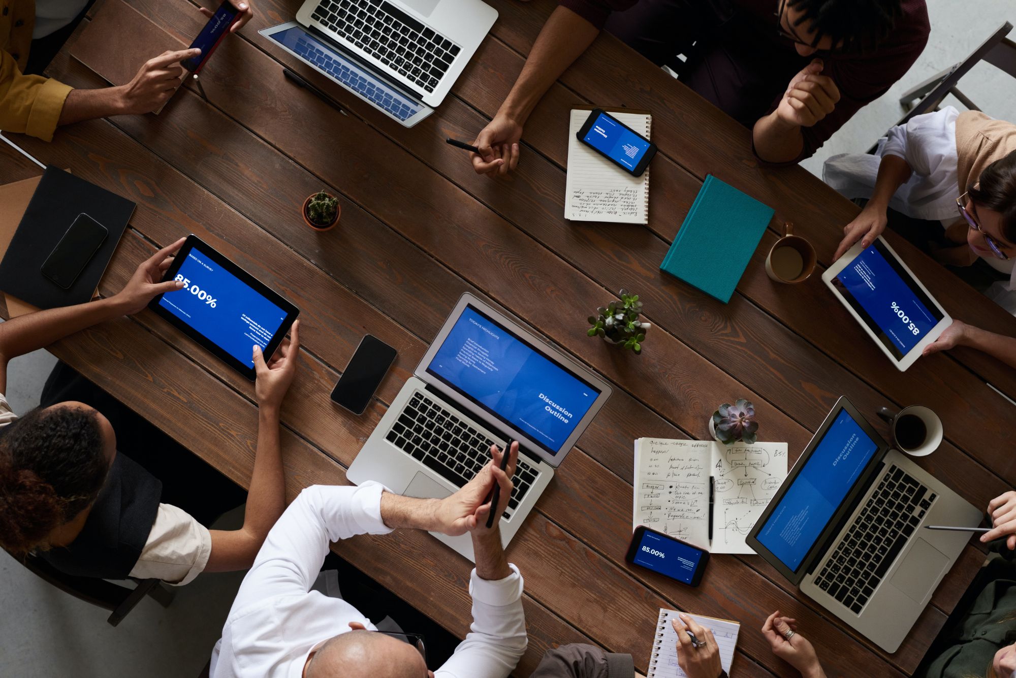 a photo from above of people working on laptops