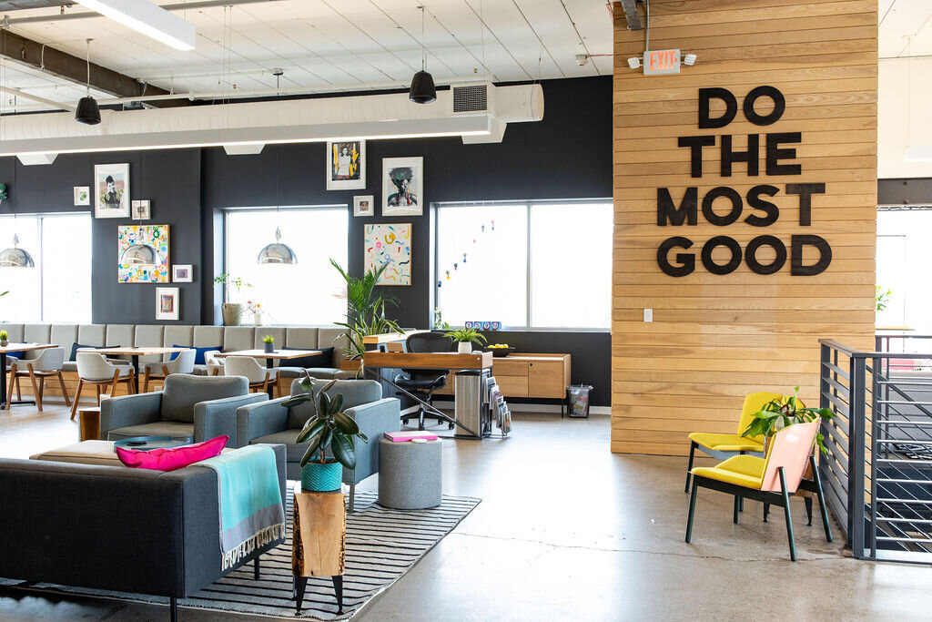 a coworking space with a writing on the wall "do the most good"