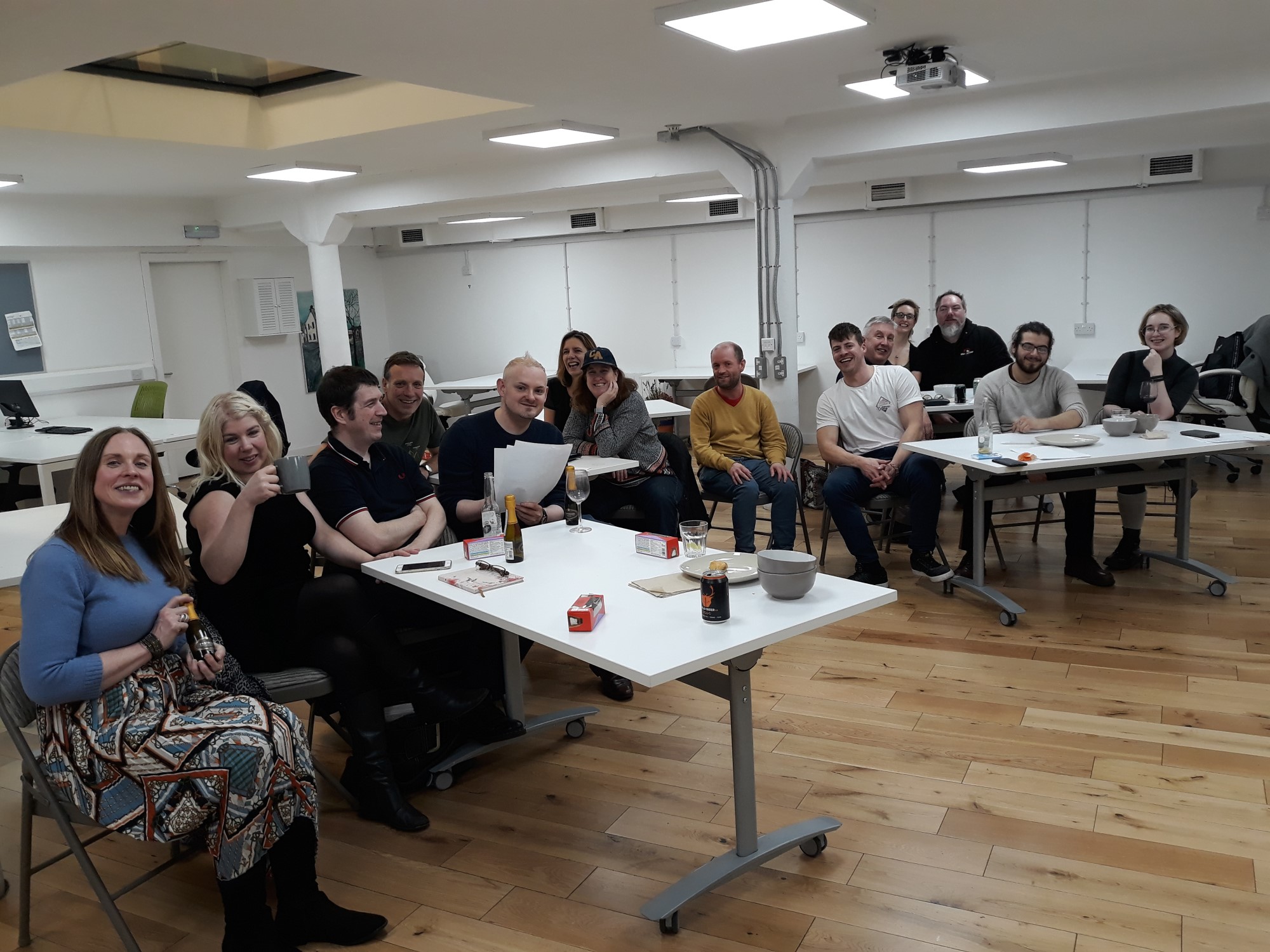 people sitting in a coworking space, talking and having drinks