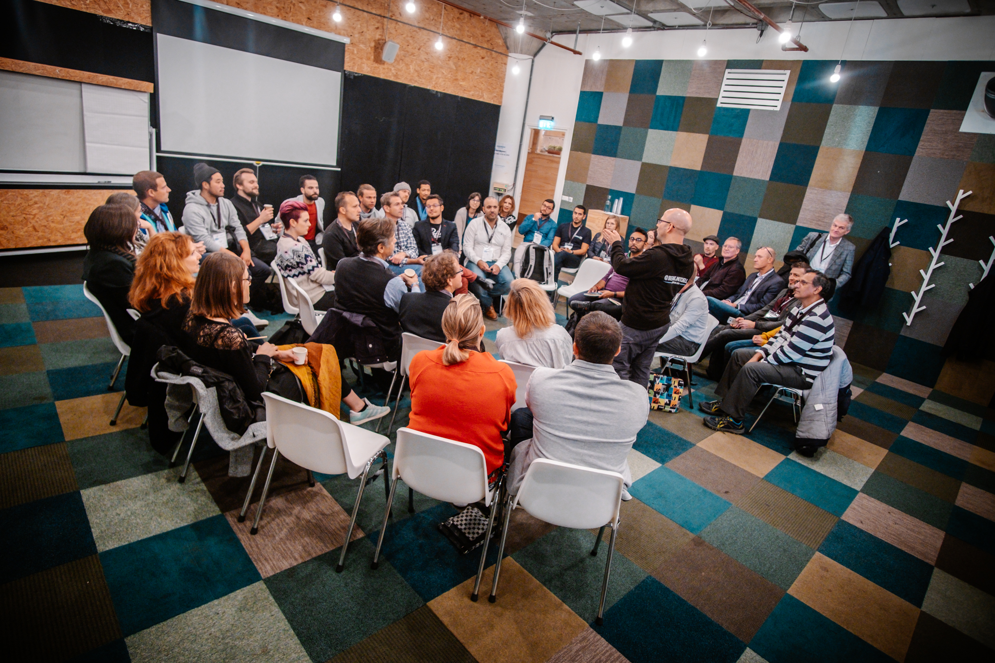 people listening to a speech at the coworking conference in poland