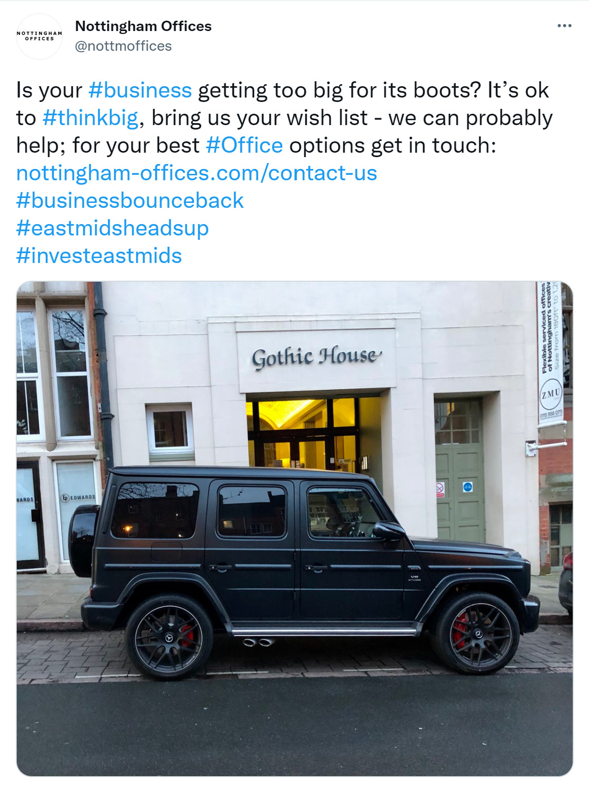 a black car parked in front of gothic house building