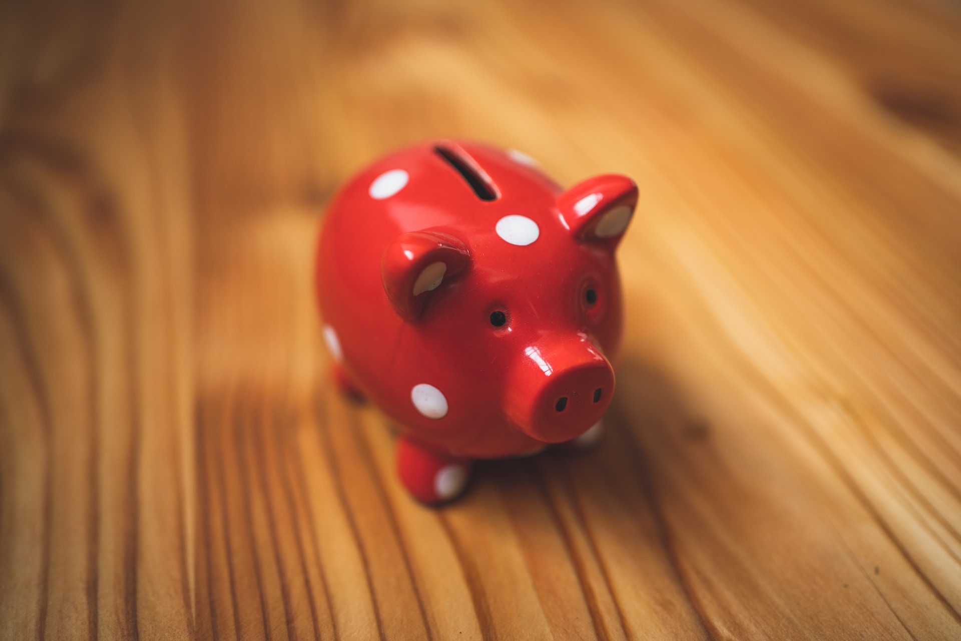 a red piggybank with white dots
