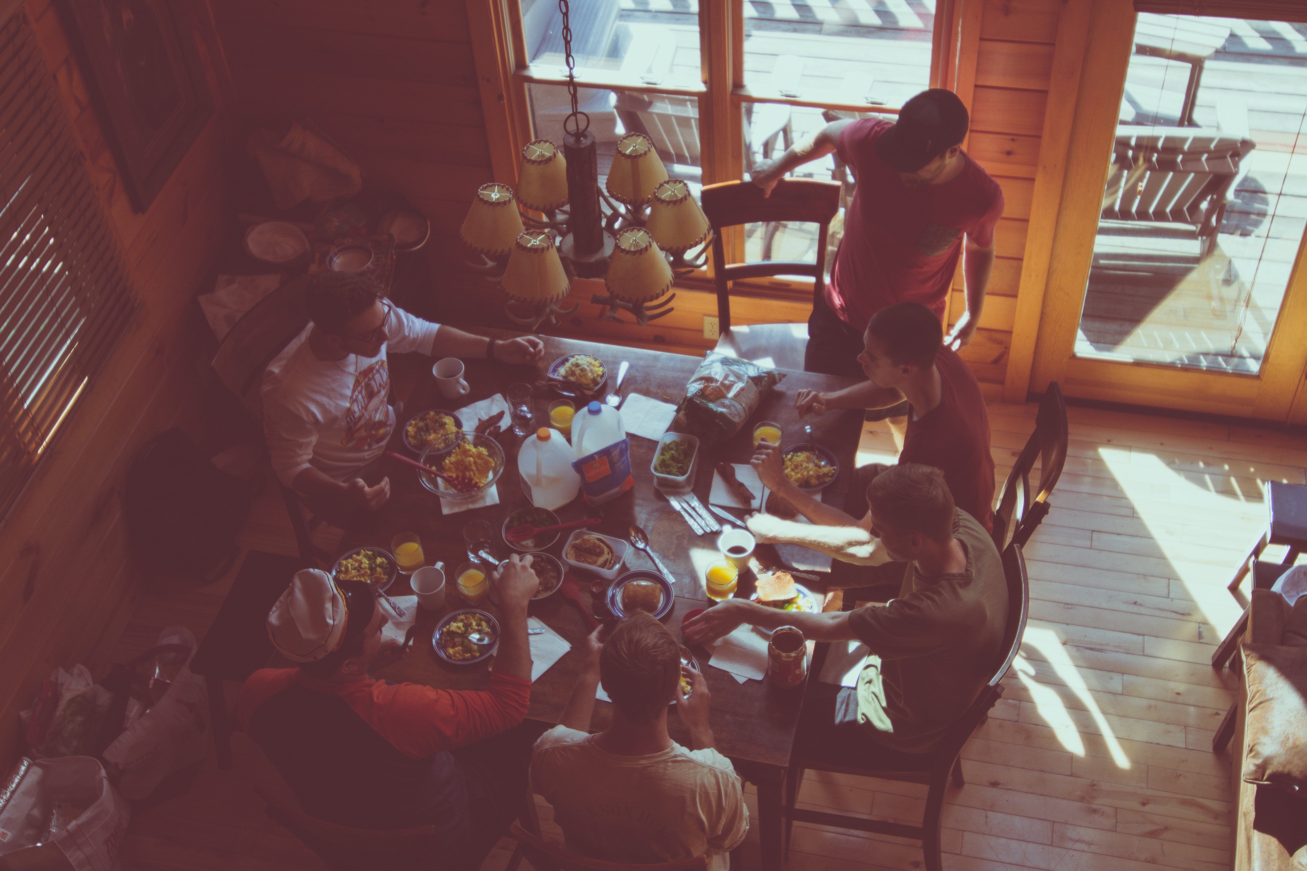 a group of people sitting at a table and eating