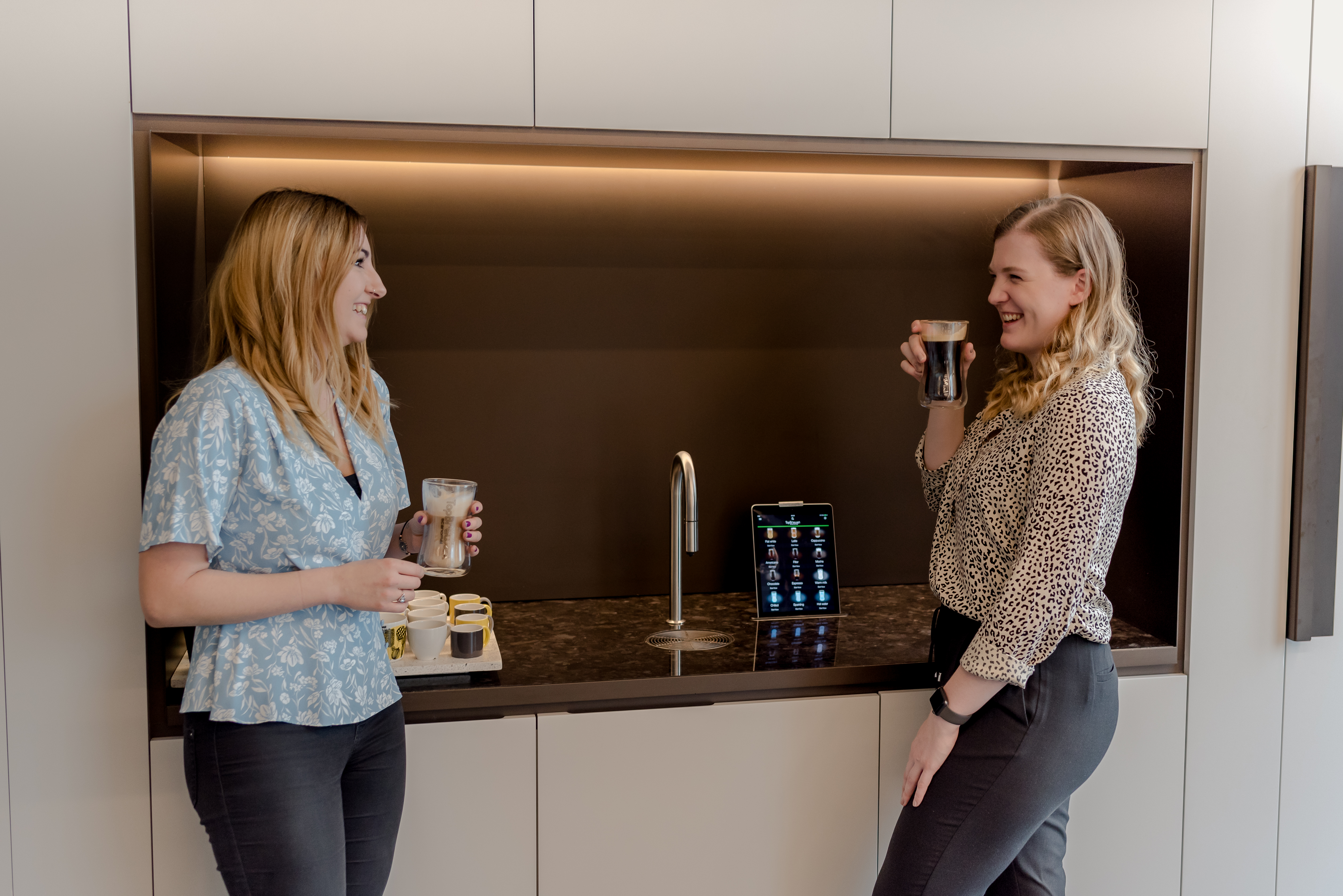 two women drinking coffee