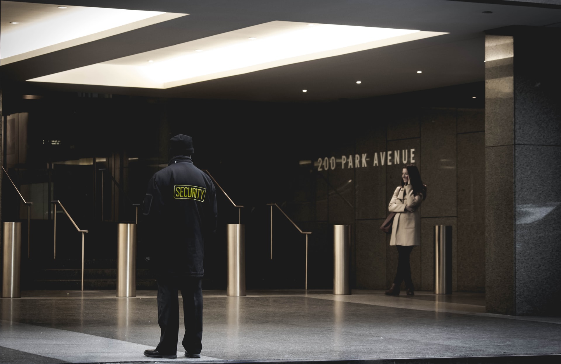 a woman and a security guard standing at the 200 park avenue