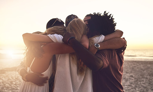 people hugging on a beach