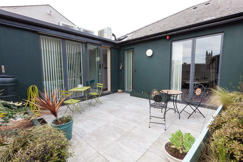 an open terrace with tables and chairs