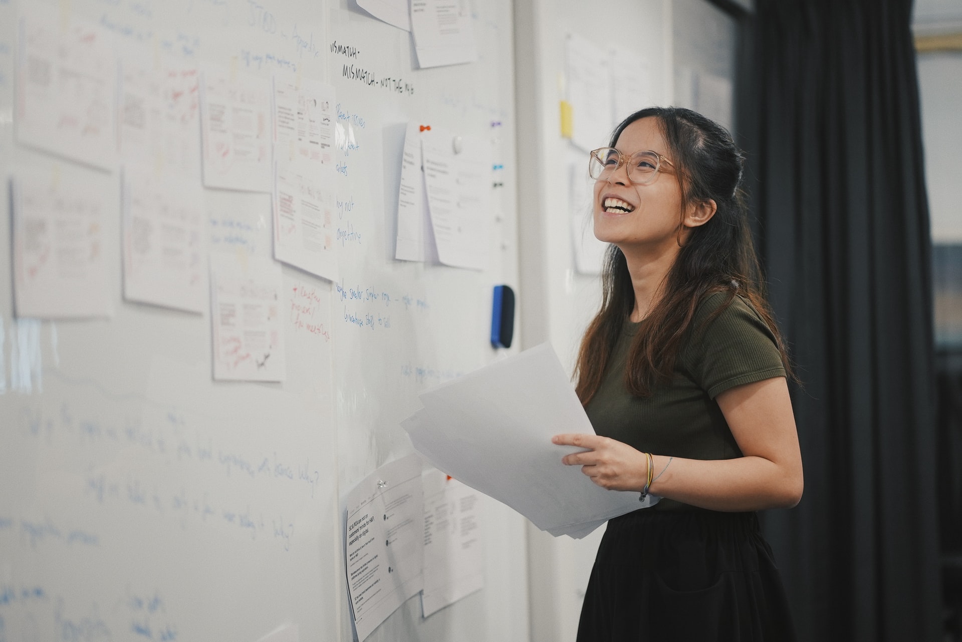 a woman writing notes on a whiteboard
