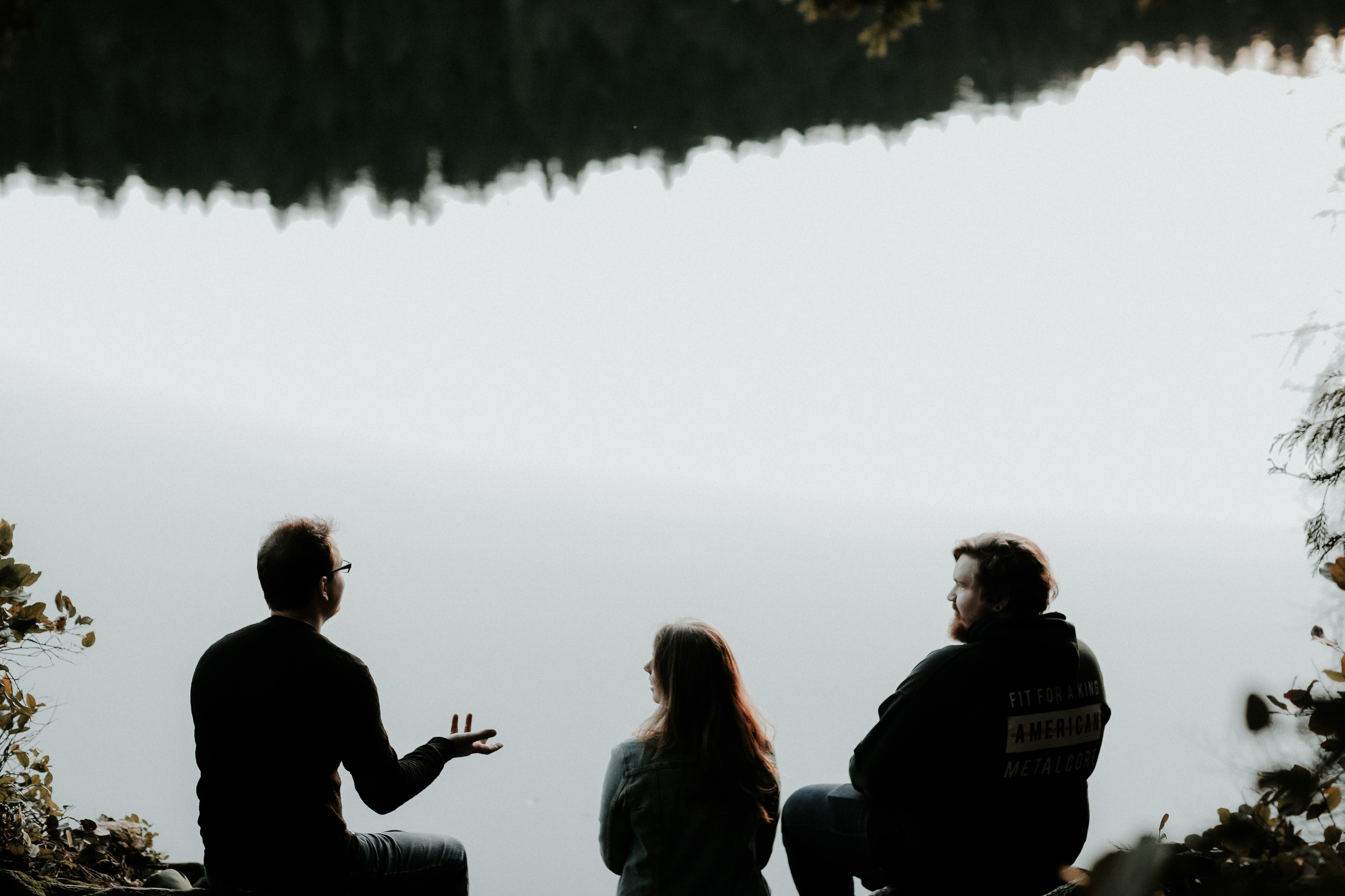 people sitting at a lake and talking