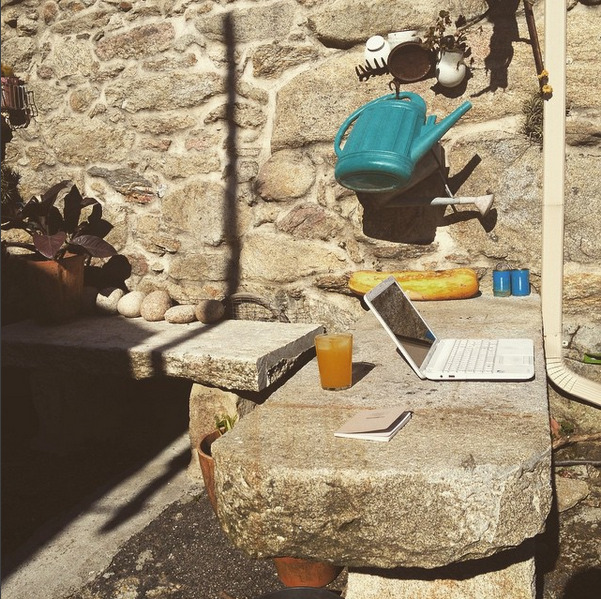 a laptop outside a rock table