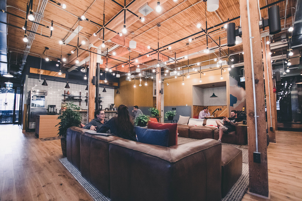 people sitting, talking, relaxing and working in a coworking space
