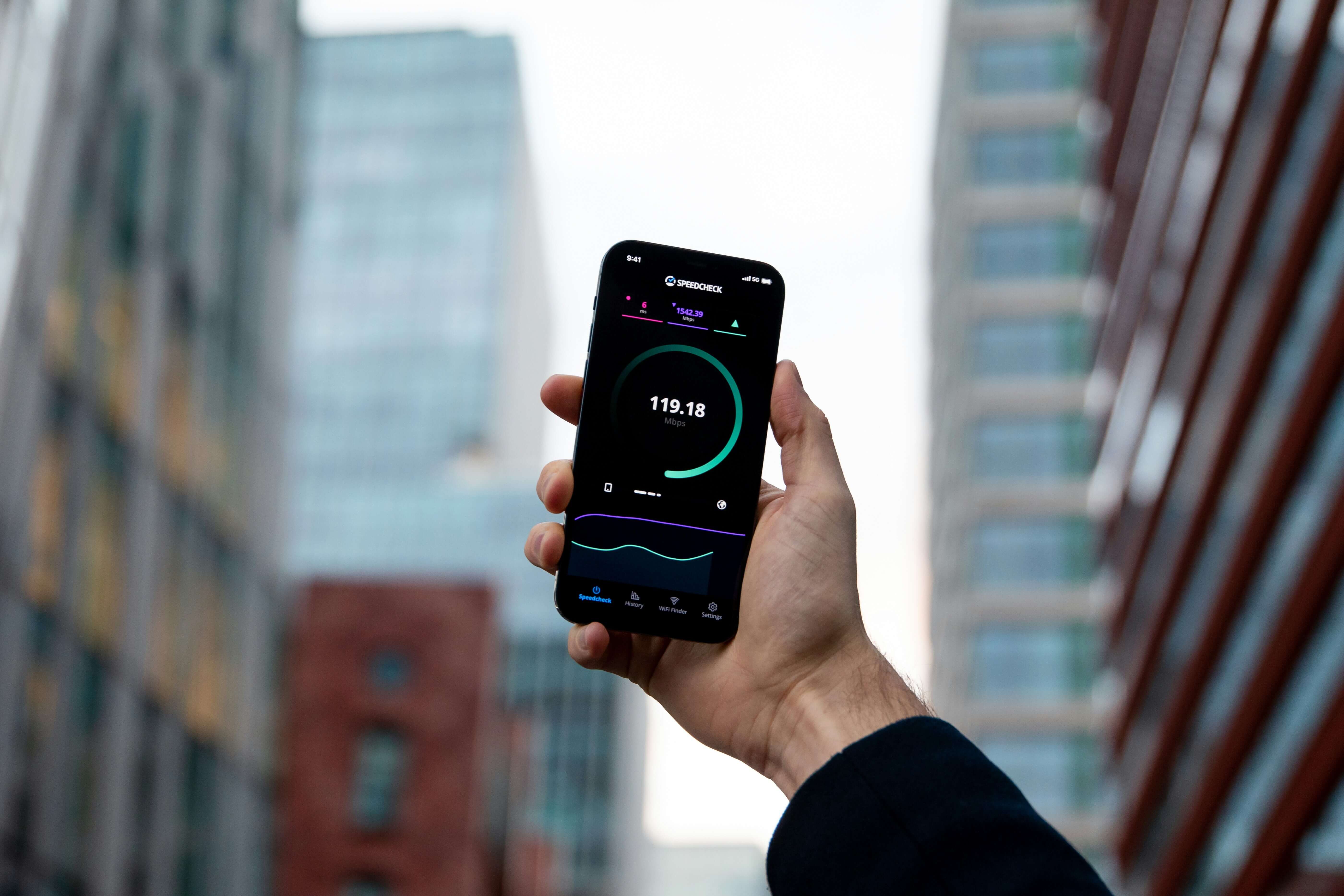 smartphone in hand, checking internet speed