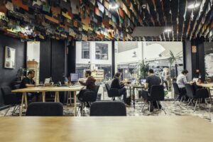 people working from a coworking office, flags on the ceiling
