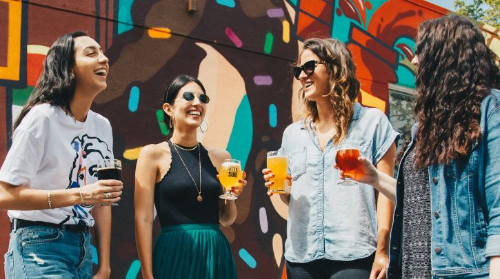 A group of women enjoying beers outside