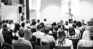 a black and white image of a seated audience