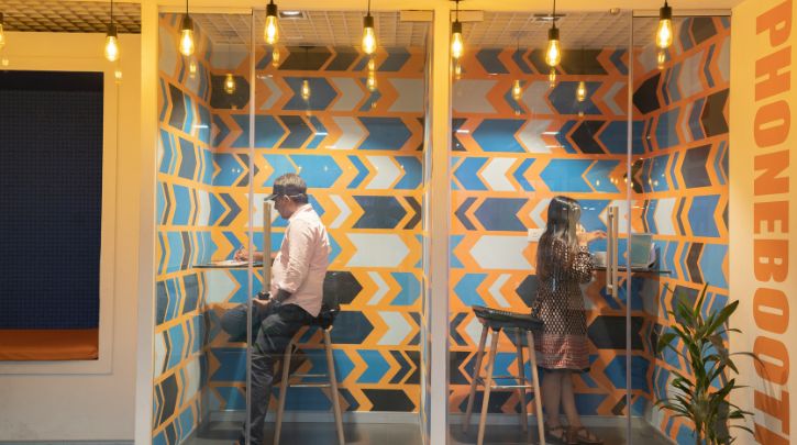 two people in call pods at a coworking space