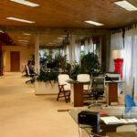 A coworking space with empty seats and desks