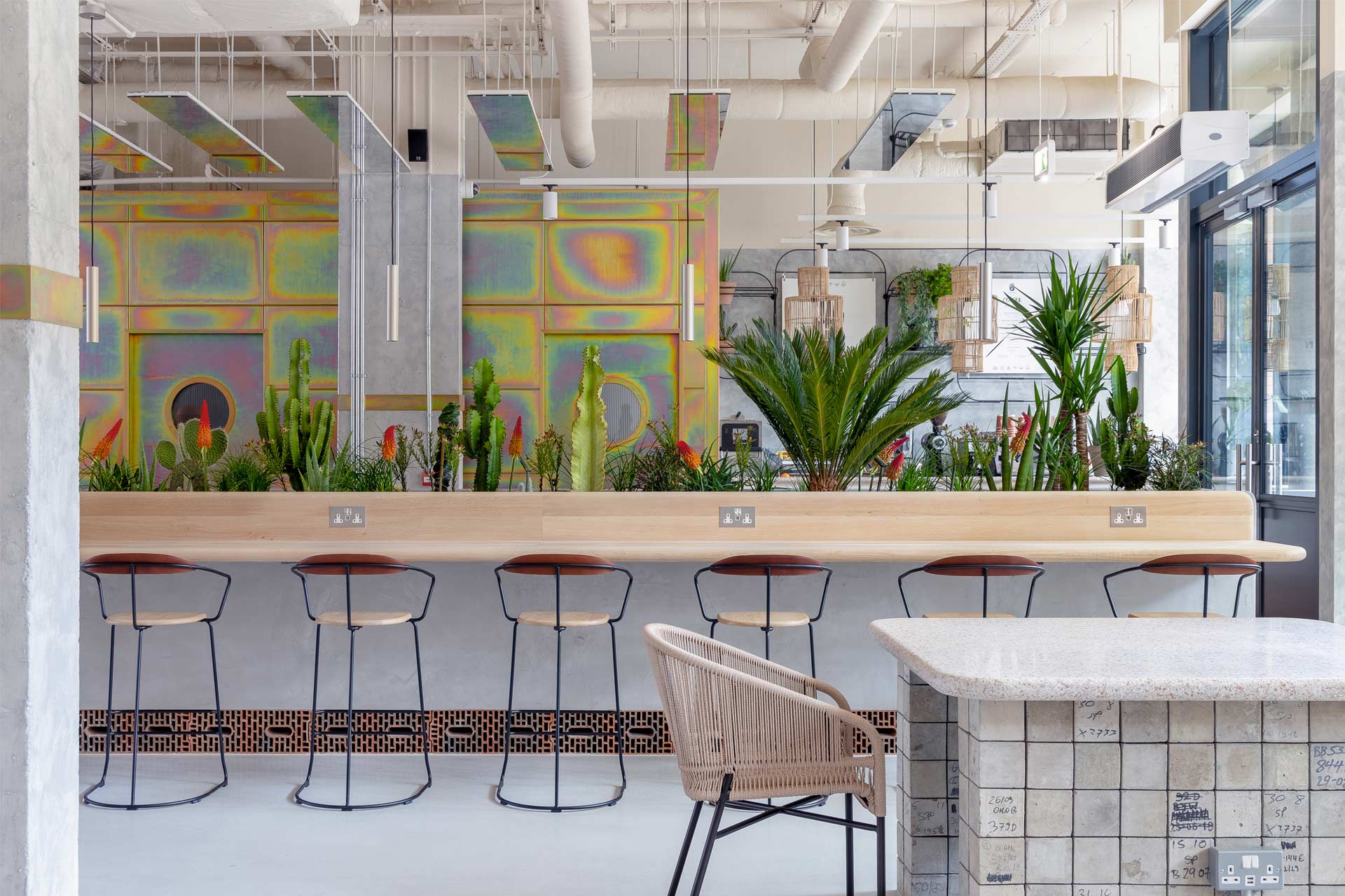 Bar tables and bistro tables with tall plants in Bermonds Locke