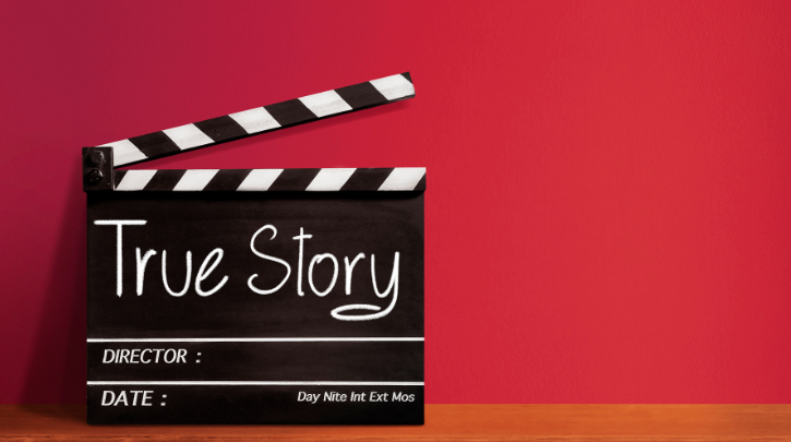 Film clapperboards that says "true story" against a red background
